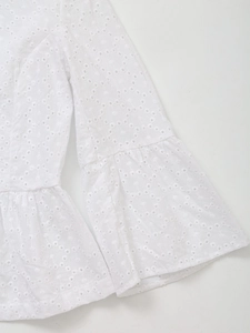 Close-up of white cotton eyelet embroidery fabric with ruffled flare sleeve detail