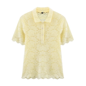 Détail du polo en maille dentelle jaune clair avec bordures festonnées et col boutonné