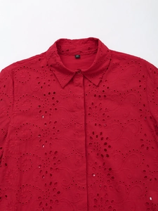 Close-up of red cotton shirt featuring intricate floral embroidery and classic collar