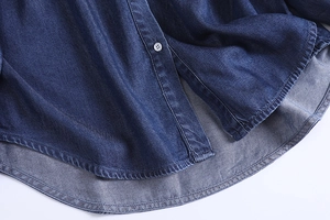 Detailed close-up of dark blue denim shirt fabric texture with high-quality resin buttons