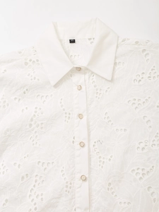 White eyelet embroidery shirt with floral lace patterns and elegant pearl buttons