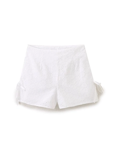 White eyelet embroidered high waist shorts with bow tie detail for a summer look