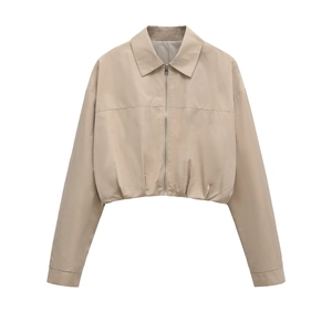 Detail of beige cropped windbreaker featuring lapel collar and metal zipper closure
