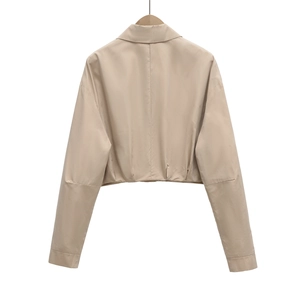 Detail view of khaki short jacket featuring a lapel collar and pleated back hem design