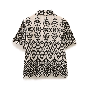 Detail of bohemian floral embroidery and hollow scalloped edge on summer short-sleeve shirt