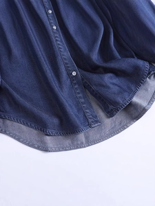Retro dark blue denim shirt with white buttons and curved asymmetrical hemline