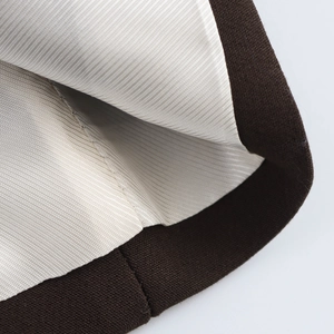 Détail de la laine marron foncé avec une doublure en satin de sergé beige lisse