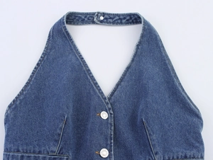 Detailed view of blue denim halter top with yellow stitching and metal buttons