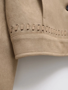 Detail of khaki faux suede jacket with intricate woven hollow trim and premium stitching