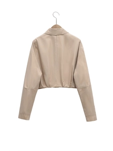 Back view of minimalist beige short jacket with lapel collar and long sleeves