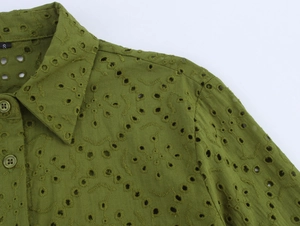 Detail of grass green embroidered eyelet shirt showing collar and resin buttons