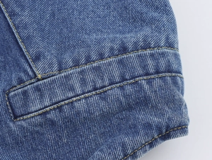 Detail of dark blue heavy denim fabric with yellow contrast stitching and twill texture