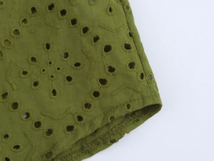Detail of olive green shirt with hollow eyelet embroidery and wavy stitch patterns