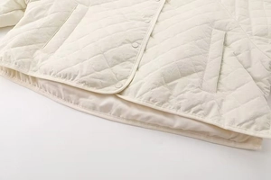 Women white quilted shirt jacket with lapel collar and snap buttons for spring