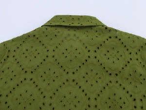 Detailed view of olive green blouse with geometric eyelet embroidery and collar design