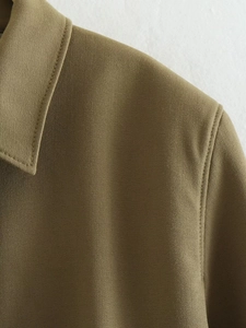 Detailed close-up of collar stitching on olive green Y2K utility pilot jacket