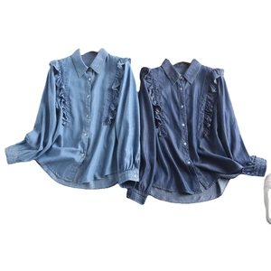 Women's denim shirt with ruffle detail and long sleeves in light and dark blue wash