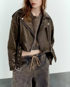 Detail of vintage coffee PU leather jacket showing classic lapel and metallic zippers