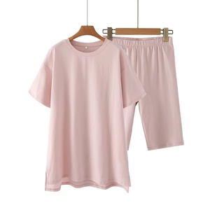 Detail of soft dusty pink lounge set featuring round neck T-shirt and loose shorts