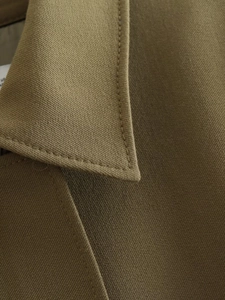 Detailed close-up of dark olive utility jacket collar showing high-quality twill fabric