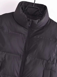 Women's black puffer vest with stand collar, windproof fabric, and zipper closure for Y2K style
