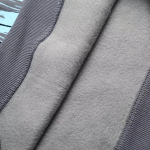 Detail of warm grey sweatshirt showing thick inner fleece lining and ribbed cuffs