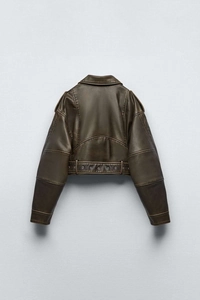 Detail view of washed faux leather jacket back with metal eyelet waist belt and panel stitching