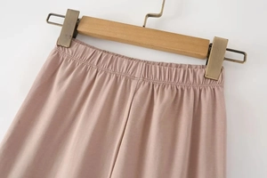 Close-up of high-waist elastic band on pink stretch leggings with soft matte fabric