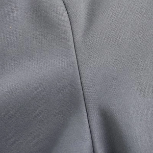 Close-up of high-quality dark grey stitching and knit fabric texture of the sweatshirt
