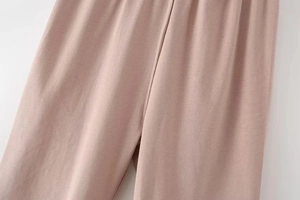 Close-up of light pink knit leggings showing high-quality stitching and soft texture