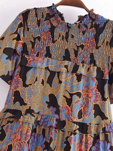 Black summer midi dress with blue floral print featuring a smocked high neck and ruffles