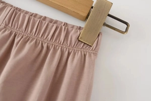 Close-up of pink elastic waistband on high-stretch slim fit knit leggings