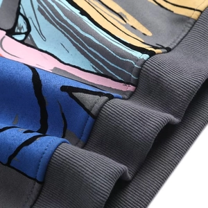 Macro view showing colorful graffiti print and thick ribbed cuffs of the Y2K sweatshirt