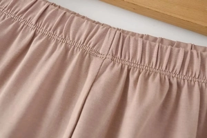 Detail of high-elasticity waistband with multi-row stitching in soft lotus pink fabric