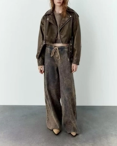 Short brown faux leather jacket and vintage washed wide-leg pants outfit for women