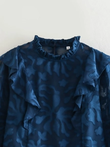 Detail of navy blue burnout floral shirt with ruffled stand collar and textured fabric