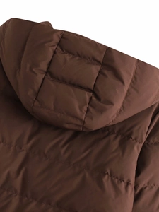 Detail view of dark brown hooded puffer jacket featuring quilted horizontal stitching