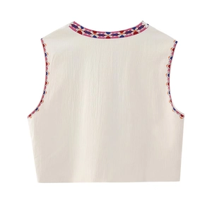 White sleeveless vest with colorful ethnic floral embroidery and vertical texture