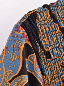 Detail of bohemian floral pattern and smocking stitch craftsmanship on summer dress