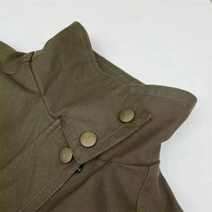 Detail of high stand collar on olive utility jacket with three vintage brass snap buttons