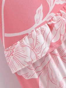 Detailed close-up of pink floral print on light cotton fabric with ruffled layers
