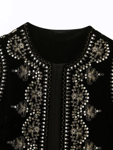 Detailed close-up of intricate gold and silver sequin floral embroidery on a black velvet vest