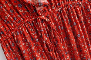 Detailed macro view of red floral fabric with drawstring design and ruffled edges