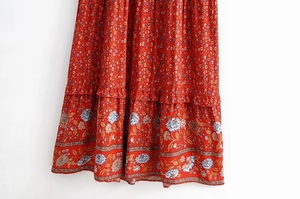 Detailed view of bohemian floral print dress with layered ruffles and white-blue flowers