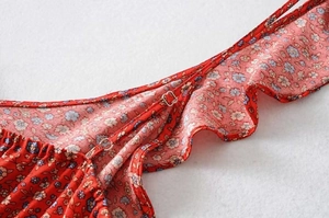 Detail view of adjustable straps and ruffled neckline on a red floral Y2K summer dress