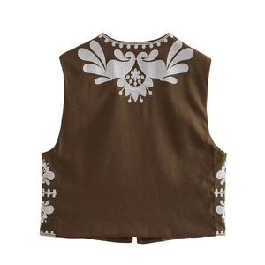 Detailed embroidery texture on a vintage brown sleeveless vest with ethnic floral patterns