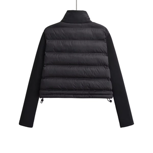Detail of black patchwork jacket featuring quilted back and adjustable drawstring hem