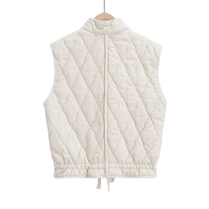 Macro view showing diamond quilting and adjustable drawstring hem on this white vest