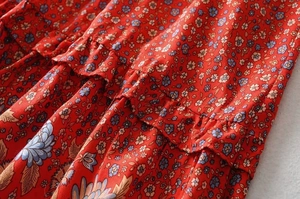 Close-up of red Y2K floral print fabric with layered ruffles and soft chiffon texture