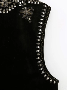 Detail of gold embroidery and silver sequins on black velvet vest for Y2K style fashion